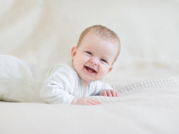 A child smiling during their teething symptoms