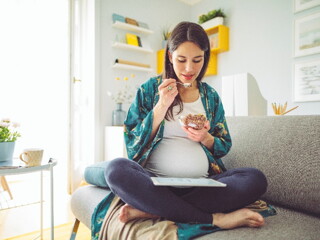 A woman indulging her pregnancy cravings in her home.