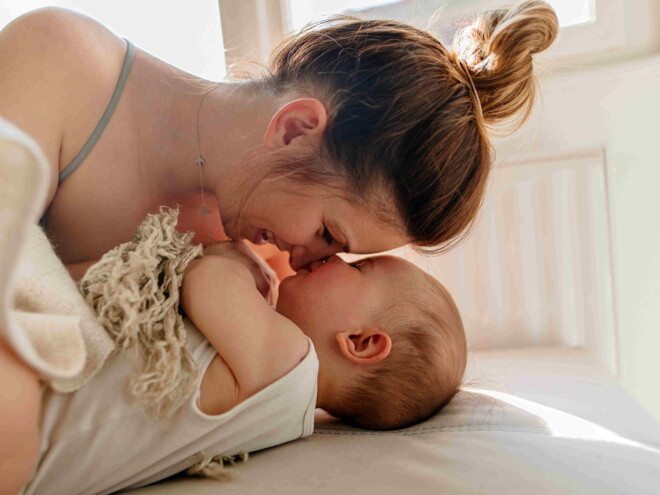 A mom and her child bonding after a baby massage.