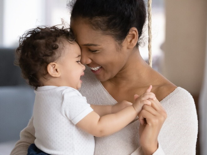 A mother holding her baby filled with new mom emotions.