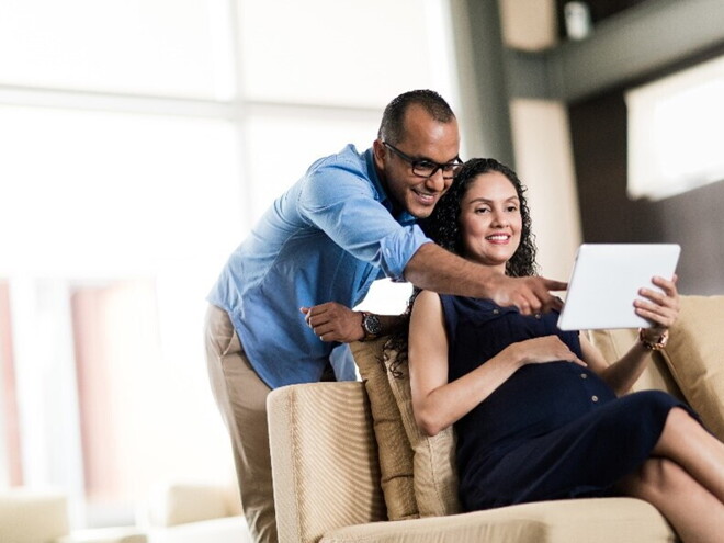 A pregnant couple preparing for parenthood.