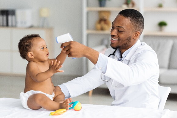 A baby getting his temperature checked by a doctor.