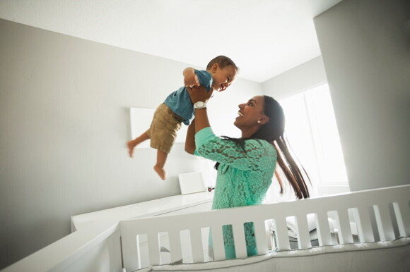 A child with his mother after sleeping in the crib.